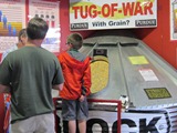 A Hoosier child learns about grain bin safety from a Breaking New Ground display.