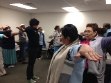 Maria Ceja (center), Bilingual outreach representative and Arthritis Foundation exercise trainer, leading participants in flexibility exercises.