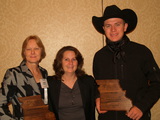 Karen Funkenbusch, Maureen Cunningham, and Zane Volkmann with his Courage Award
