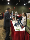 Abbie Spackmman talking with client at Farm Bureau Health & Safety Fair