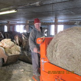 VT AgrAbility farmer with bale un-roller