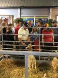 Sonny Perdue with crowd at petting zoo at Indiiana State Fair