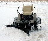 Trac-vac snow blade on mower in snowy conditions