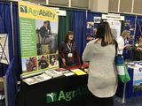Darlene Carlisle talking with attendees at the AgrAbility AOTA exhibit.