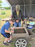 Ron Harwood and boy working on composting