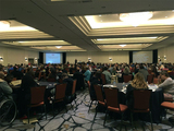 Photo of attendees at APRIL conference opening session in hotel ballroom