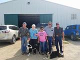 P.H.A.R.M. Dog recipients and a trainer