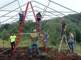 Marines helping TNAP clients, the Trosts, put up a greenhouse