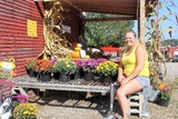 Jill Nichols next to flower pots