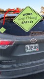 Sign on back of car "Work Keep Fishing Safely"