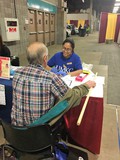 UMKC pharmacy student doing health screening at Western Farm Show