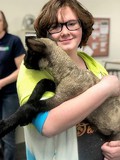 Female student holding lamb