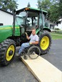 Doug VerHoeven in wheelchair by tractor