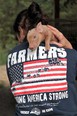 Pig over woman's shoulder with t-shirt "Farmers Making America Strong"