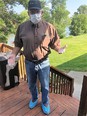 Rod wearing PPE mask - gloves - and shoe coverings - while standing on a wood deck