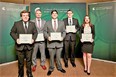 Picture of 5 people - 4 men and 1 woman - standing in suits and holding their ME Edison award certificates with a green poster background that reads College of Engineering Michigan State University