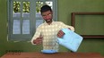 Image from an animation showing an African man in a roomwith green walls pouring something from a blue 2 gallon container into a shallow blue bowl with a window behind him