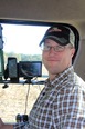 Picture of Jed Welder from the waist up sitting in a tractor cab.