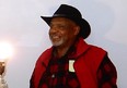 African American Viet Nam veteran wearing red and black plaid flannerl shirt, red vest, and black hat