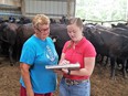 Brenda Schreck facilitating an onsite farm assessment with Sharon Schlager with black cattle in the background