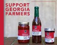 2 glass jars sitting on each side of a bottle with salsa-marinade-jam on a brick base with a title in upper left SUPPORT GEORGIA FARMERS