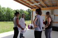 4 young women standing in an open pole barn - part of the integrated STEM interns