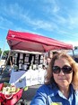 Selfie of Betty Rodriguez in front of NC AgrAbility booth at China Grove