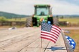 Small US flag on wood trailer in back of John Deere tractor