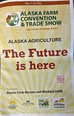 Flyer in yellow-red-black saying ALASKA FARM CONVENTION & TRADE SHOW - ALASKA AGRICULTURE - THE FUTURE IS HERE