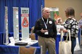 Man - Roger Tormoehlen - at Gearing Up For Safety booth talking with woman