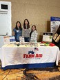 CA AgrAbility staff - 3 women - at Farm Aid booth