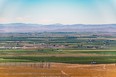 Fertile valley with farmlands & mountains in background in WA state