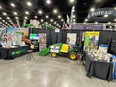 National AgrAbility booth at National Farm Machinery Show with modified John Deere tractor in center.
