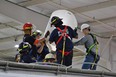 Six people in harnesses practicing grain bin rescue procedures