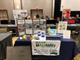 Maine AgrAbility table display in a large room with other booths