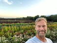 Selfie of Charlie Jordon with a beautiful flower field behind him