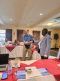 Chuck Baldwin demonstrating gripping aid assistive technology with Dr. David Agole at AgrAbility for Africa workshop.