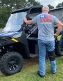 Man with back to camera wearing FREEDOM t-shirt while looking at UTV