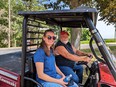 WI AgrAbility staff - Annie - riding in UTV with man on Stinson farm.