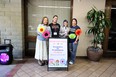 California AgrAbility staff standing outside building behind sign that reads BIENVENIDOS ENCUENTRO DE PROMOTORES