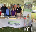 TN AgrAbility team L to R - Finis Stribling - Joetta White - Eileen Legault - Troy Dugger standing behind TN AgrAbility display table under white tent