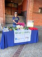 Woman staffing a CA AgrAbility booth at the  2nd Annual Yolo Farmworkers and Growers Festival