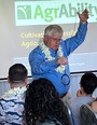 Bill Field wearing a Hawaiian lei and using a ring on a chain illustration at the Hawaii Regional Workshop