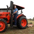 TN AgrAbility client on a Kubota tractor with a LifeLyfts lift on it.