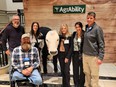 Florida AgrAbility group of 3 men - 1 in a wheelchair - & 3 women standing around animatronic bull T-Bone