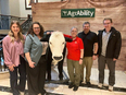 NE AgrAbility's team standing next to animatronic bull T-bone at NTW