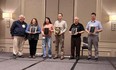 Bill Field on left next to 2 women and 3 men holding AgrAbility sevice award plaques