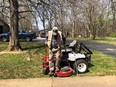 Paulus Shelby - elderly farmer - descending from his AT-modified zero-turn mower in a yard under a large bare tree
