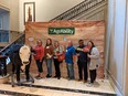 TX AgrAbility personnel standing under AgrAbility sign next to animatronic bull T-bone