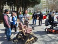 Kyle Haney talking to mixed group standing around a TrackChair outside hotel in Atlanta